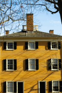 Family posing in front of a historic Salem Massachusetts building with kids excited for adventure.