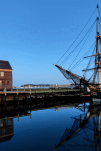 A joyful family enjoying a tour in Salem Massachusetts with children marveling at historical displays.