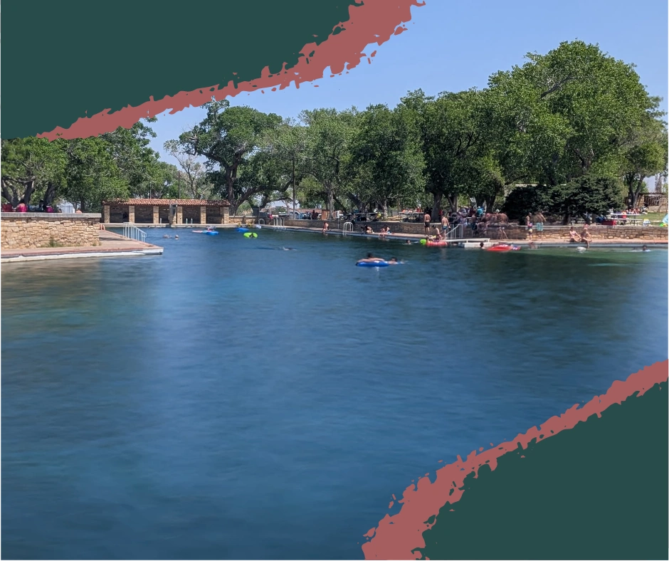 Wide view of the crystal-clear swimming pool at Balmorhea State Park, Texas, with San Solomon Courts, mountains, and patio seating visible. Balmorhea State Park Toyahvale TX.