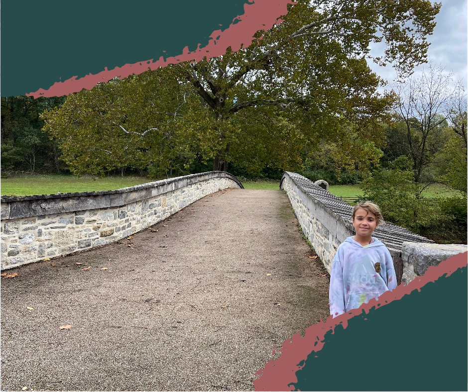Our young traveler stands proudly in front of Burnside Bridge, wearing a freshly earned Junior Ranger badge. A symbol of learning, growth, and honoring the past through youth exploration.