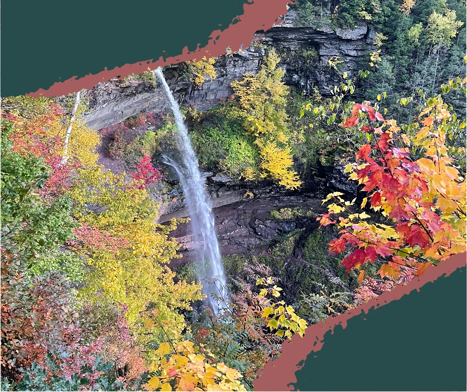 Kaaterskill Falls surrounded by vibrant autumn foliage with red, orange, and yellow leaves, creating a stunning contrast against the waterfall. Kaaterskill Falls, fall foliage Catskills, autumn leaves, Catskill Mountains waterfall, Kaaterskill Falls fall view, autumn Catskills, waterfall photography, fall in the Catskills, Catskills nature, scenic Catskills views. Things to do in the Catskill Mountains, NY.
