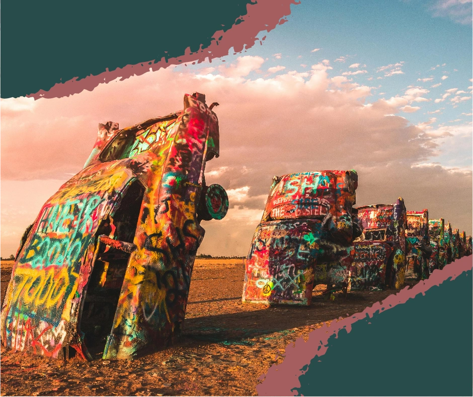 Graffiti-covered Cadillacs buried nose-first in the ground at Cadillac Ranch, Texas