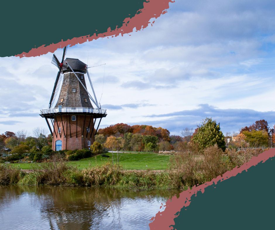 Historic Dutch windmill surrounded by colorful tulip beds at Windmill Island Gardens in Holland, Michigan. Free Season. Things to do in Holland MI.