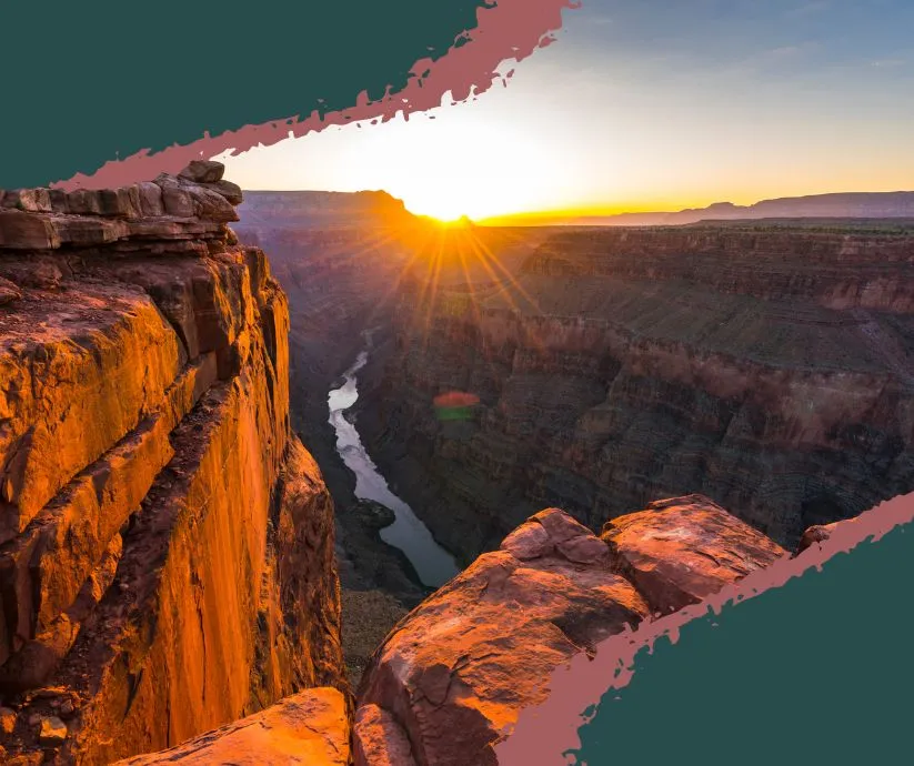 Hiker standing on a cliff overlooking the Grand Canyon during sunrise